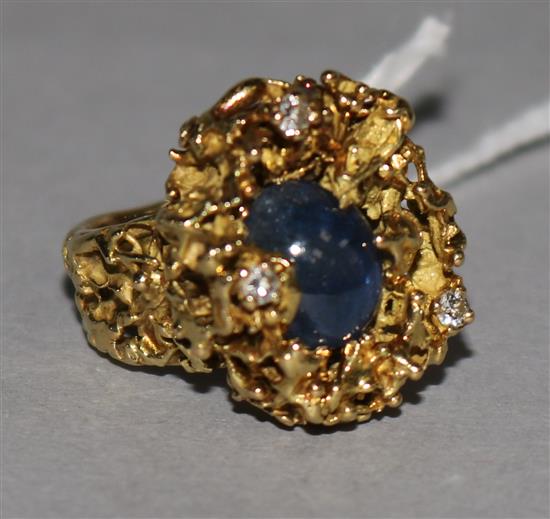 A modernist 18ct textured gold, cabochon sapphire and diamond dress ring, size E.